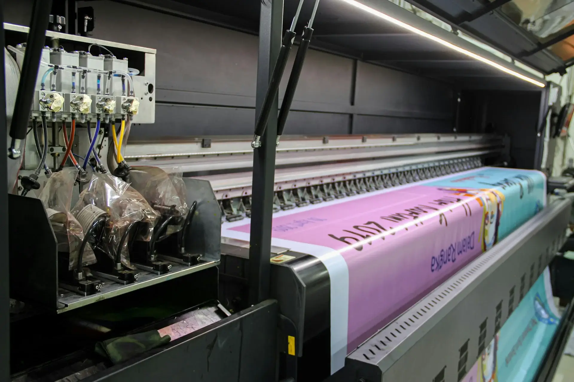 High-quality offset printing machine producing colorful banners at Ashoka Computer - professional printing services